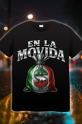 “En La Movida T-shirt design with metallic lettering and Mexican flag money bag over a blurred city lights background”
